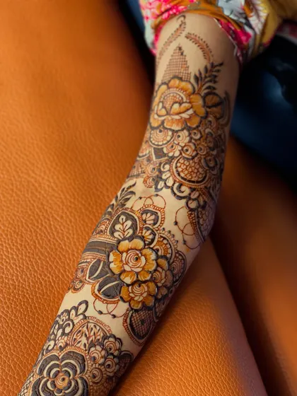 A close-up of a floral design on the forearm. The use of light and dark shading gives the flowers a three-dimensional feel.