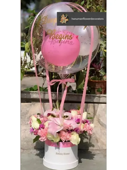 Beyond just decorating the venue, I also create beautiful floral gifts. This is a custom hot-air-balloon style arrangement, with fresh flowers in a box and a personalized balloon, perfect for a birthday or anniversary present.