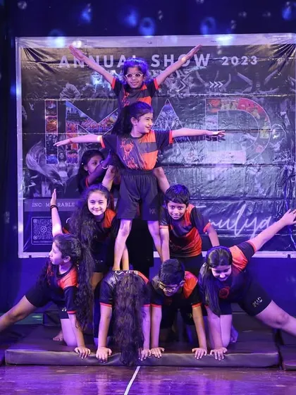 A full-stage view of one of our impressive human pyramids from the 'Tarulya' 2023 showcase. This demonstrates the culmination of months of practice in balance, strength, and trust.