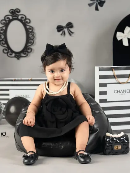 A different pose in the same chic setup, this time on a comfy beanbag. She looks so poised and cute.