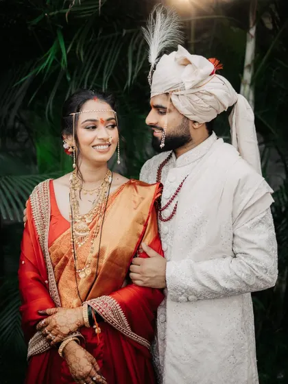 A classic, happy portrait of the couple, the groom's arm gently around his bride.