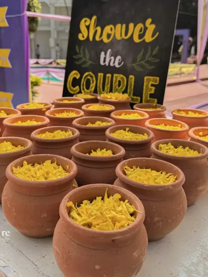 A creative and interactive detail for a Haldi ceremony. Guests were invited to 'shower the couple' with flower petals from these charming little mud pots, adding a rustic and personal touch to the celebration.