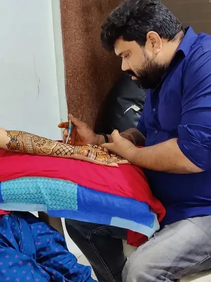 The mehndi session is a special part of the wedding festivities. Here I am working with a bride, ensuring she is comfortable while I create her intricate design.