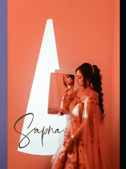 A bridal portrait using a projector to cast a sharp, graphic shape of light, creating a modern and artistic composition.