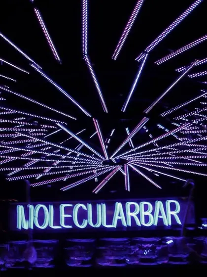 The futuristic 'Molecular Bar' setup for our 'Neon Love' Sangeet, with geometric neon lights creating an electrifying ceiling installation.