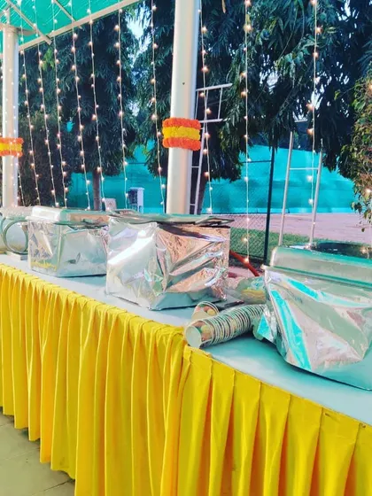 Our buffet setup for a Mehandi dinner, with bright yellow table skirting to match the festive decor. The food is kept hot and fresh in insulated containers before service.