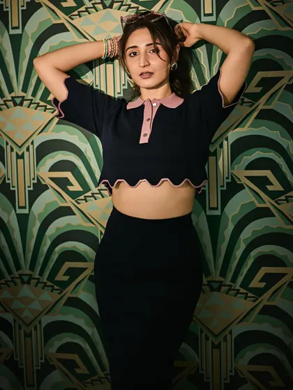 A more playful pose in the same stylish outfit. This shows how a great outfit can be versatile enough for both serious and fun shots.