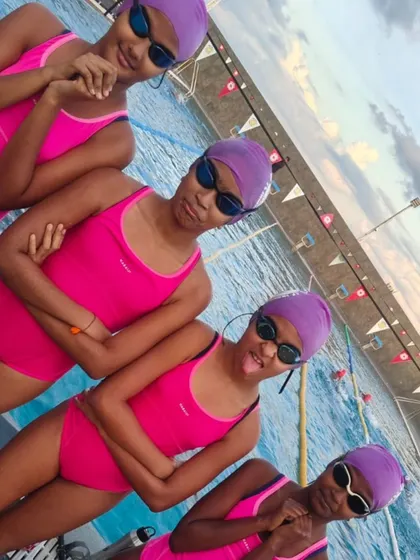 The girls showing off their team spirit and personality. We work hard in the pool, but we always make time for fun.