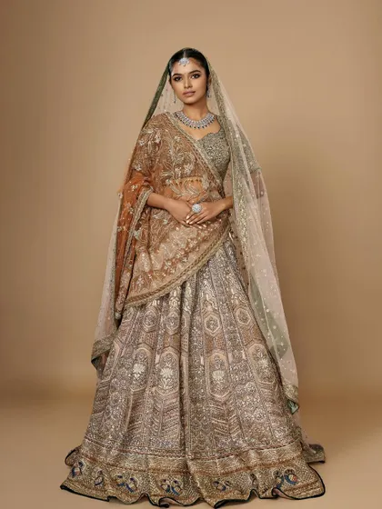 A full-length view of a unique bridal lehenga, showing how my student Simran adapted the makeup to suit a non-traditional color palette.