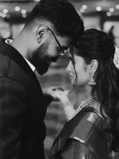 A dramatic and intimate black and white portrait of the couple. This artistic shot focuses on their connection and the emotion of the moment, creating a timeless image.