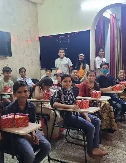 Distributing gifts to our students during the Diwali celebration. Seeing their happy faces is the best part of any festival.
