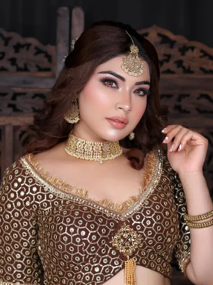 A confident pose that showcases the beautiful blend of colors in the makeup and the intricate details of the outfit.