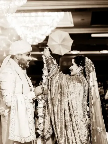 A sepia-toned version of the Varmala ceremony, giving it a timeless, vintage feel. The sparklers and smoke create a truly spectacular and memorable scene.
