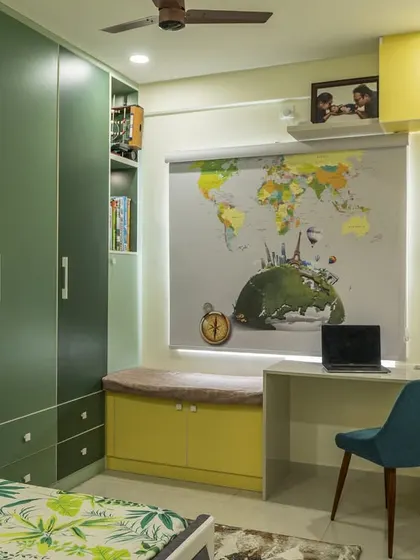 A closer look at the study nook in the kids' room, with a desk positioned under the window for natural light and open shelves for easy access to supplies.
