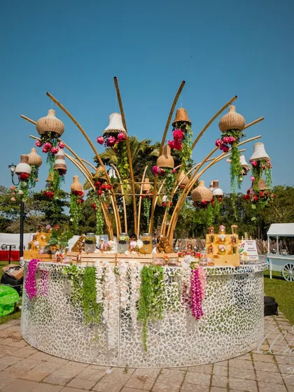 The bar at this Mehendi was a centerpiece in itself. The circular mirror-paneled bar is topped with an artistic arrangement of bamboo, lampshades, and florals, making it both functional and a decor statement.