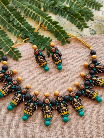 A variation of the Mahalakshmi motif necklace, this one with sea-green beads. Providing color options for traditional designs is important for matching with different outfits.