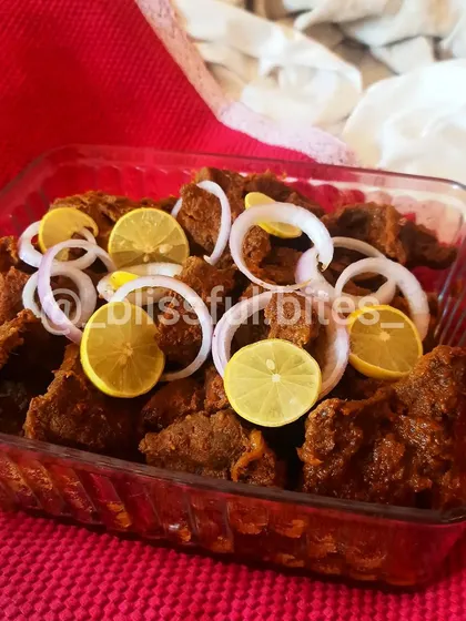 This is my Steak Phaal, an intensely flavorful and spicy Indian-style steak dish. The meat is marinated and cooked in a thick masala until tender, then served with fresh onion rings and lemon wedges to balance the heat.