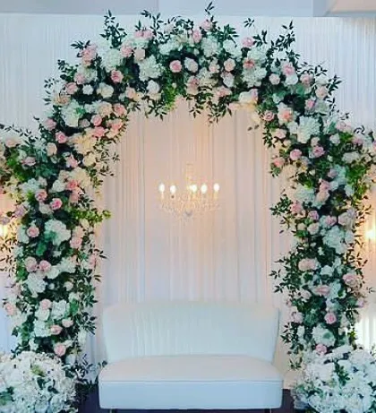 A stunning triple-arch floral backdrop. This design creates a sense of depth and grandeur, perfect for a large stage or a magnificent photo wall.