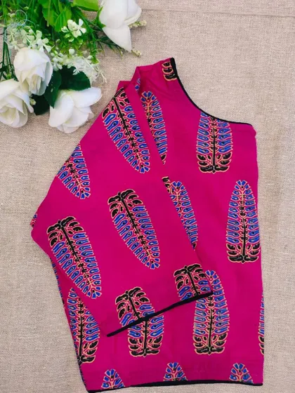 A pure cotton boatneck ready-made blouse in a vibrant pink with a traditional printed design.