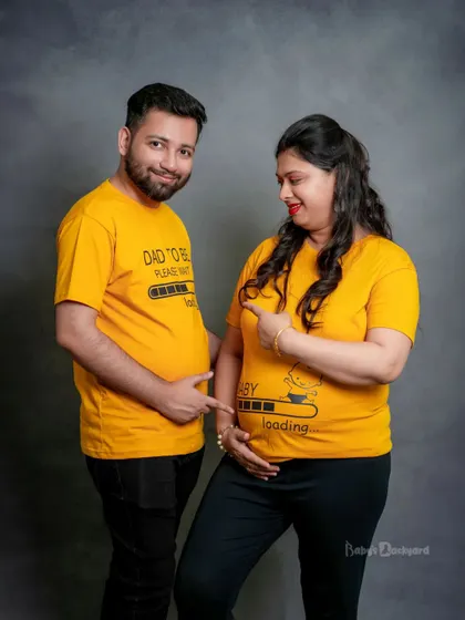 Baby loading, please wait! We love when couples bring their fun side to the shoot with playful props like these matching t-shirts for the dad-to-be and mom-to-be.