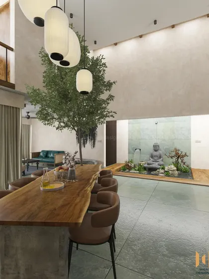 A serene villa where rustic meets contemporary. This space features a live-edge dining table, an indoor tree, and a tranquil water feature with a Buddha statue.