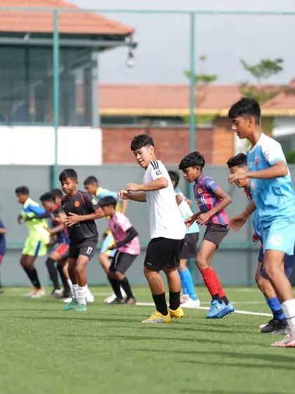 Players ready to explode off the line during a speed drill at our academy trials.