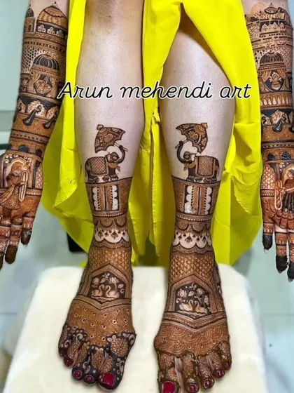 A royal-themed full bridal mehendi. The hands feature portraits and doli scenes, while the feet have matching elephant motifs.