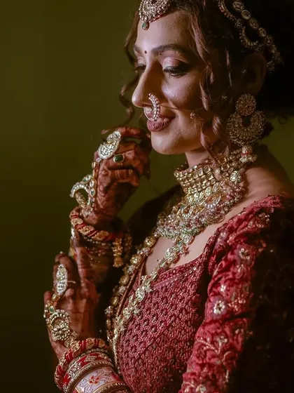 A beautiful, smiling portrait of the bride, with soft lighting that highlights her features and jewelry.