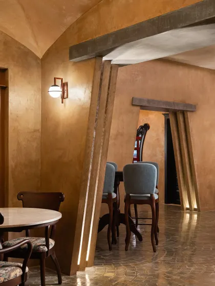 A detail from our design for Watson's Pub in Kochi. The offset play in the flat arch and the inclined wall adds a contemporary twist to the space, which is finished in warm, earthy lime plaster.