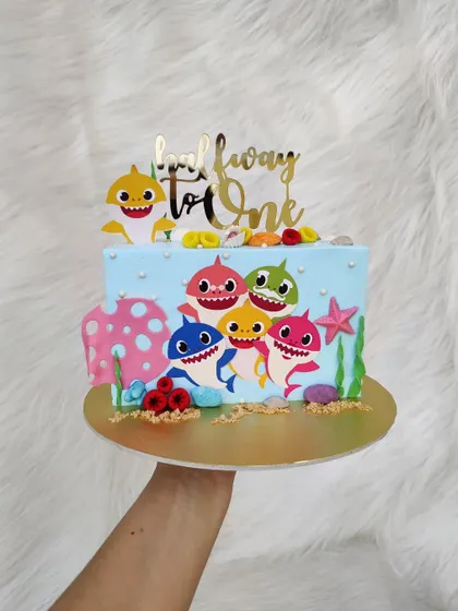 Celebrating "halfway to one" with a Baby Shark theme. This cake features the whole shark family and is perfect for a six-month milestone.