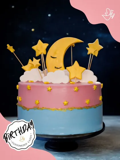 A dreamy night sky cake, featuring a sleeping moon, fluffy clouds, and golden stars. This whimsical design is perfect for celebrating a little dreamer's birthday.
