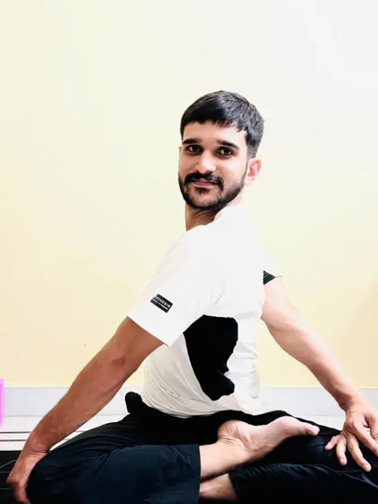 A deeper variation of the seated spinal twist, demonstrating how the pose can evolve with practice.