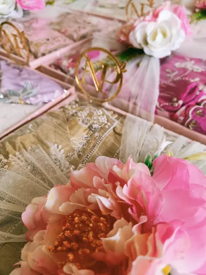A detailed shot of the custom monogram and floral decorations on a trousseau tray. The large pink peony adds a bold and beautiful statement.