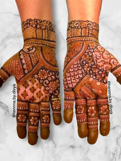 This intricate Indian mehendi design is filled with a variety of patterns, including floral, paisley, and jaali work. The asymmetry gives it a modern and artistic feel.