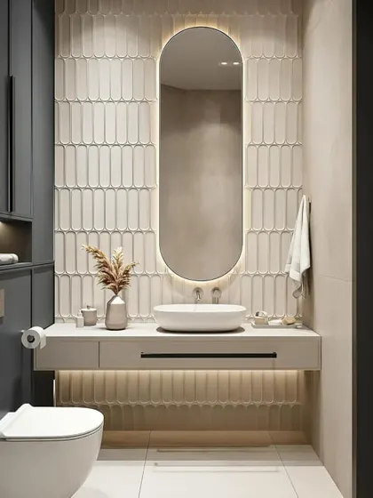 I love the texture in this bathroom. The wall behind the oval mirror is covered in beautiful, vertically laid tiles that catch the light perfectly. The dark cabinets provide a nice contrast.