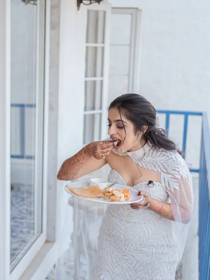 A real and relatable moment of the bride grabbing a bite to eat on her balcony. It’s our job to capture the unscripted parts of the day, because sometimes the best memories are a little messy.