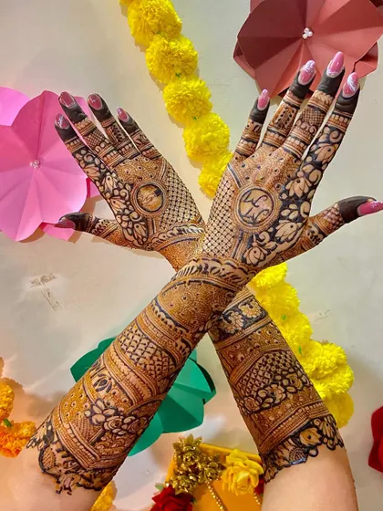 A creative shot of the bridal mehendi against a colorful background.