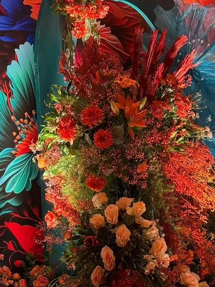 For this Bhaat function, I used a vibrant, artistic backdrop of oversized, colorful flowers. The real floral arrangements in fiery reds and oranges in the foreground create a stunning 3D effect, embracing the beauty of bold color and pattern.