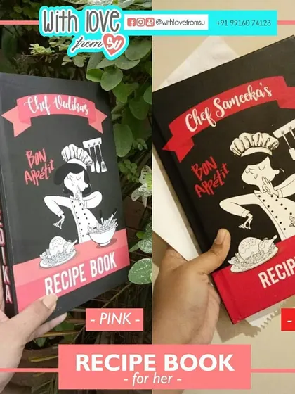 A look at two custom recipe books designed for her, showing different color options in pink and red. Each cover features a unique chef caricature and the recipient's name for a truly personal touch.