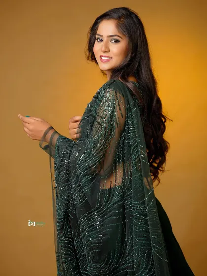 A smiling, over-the-shoulder pose that feels playful and engaging. It’s a great way to show off the back details of an outfit while capturing a happy expression.