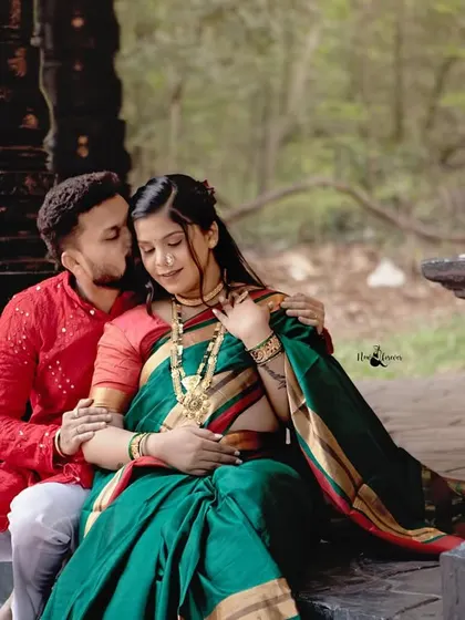 A sweet kiss and a gentle embrace. The traditional attire and temple setting make this intimate moment feel sacred and special.