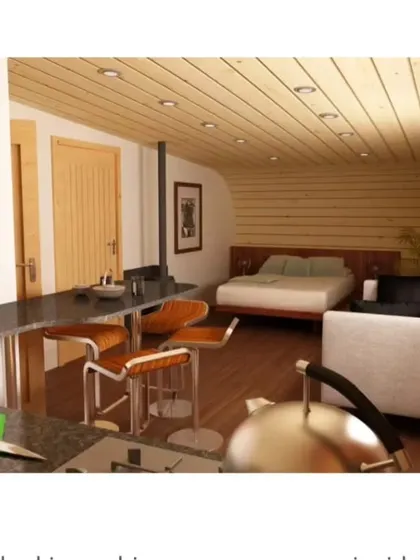 This unique "log-like" cabin design shows our creative potential. The exterior is a loop of shingles, while the interior is a cozy, fully-equipped living space with a kitchen, bed, and seating area.