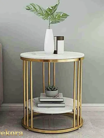 A clean and contemporary two-tier side table with a cylindrical gold-finish metal frame. The white marble-finish surfaces are perfect for displaying decor items, making it a versatile addition to any living space or bedroom.