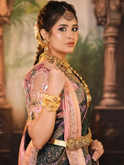 Notice the traditional braided hairstyle with floral accessories, another key element of the bridal hairstyling module in my course.