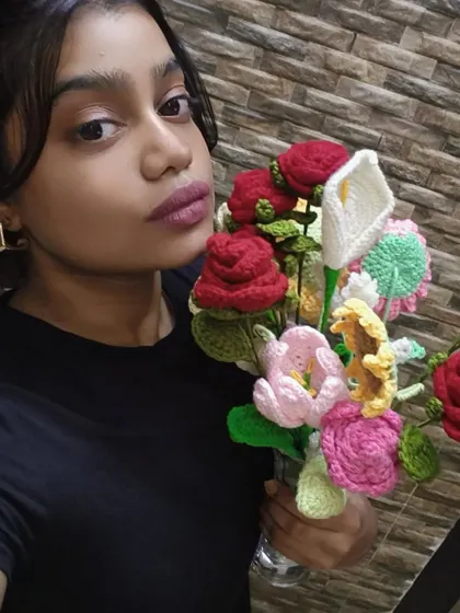 Here I am holding a large, mixed bouquet I created. It features red roses, calla lilies, and other colorful flowers, showing the variety of custom arrangements I can make.