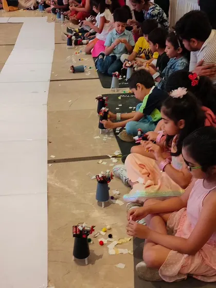 A long line of young builders, each focused on constructing their own robot. This shows how we can manage and engage a large group of kids in a single, exciting activity.