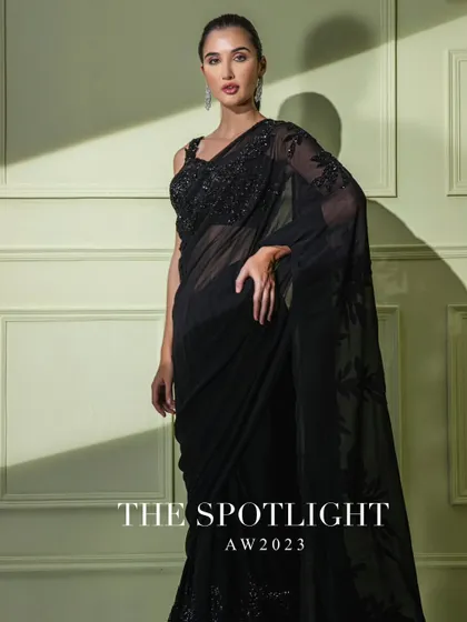 A campaign shot of the black floral embroidered saree, a timeless piece from "The Spotlight" collection.