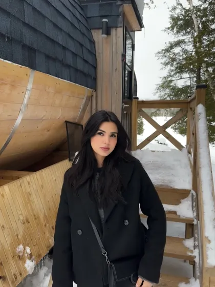 A close-up portrait in my all-black winter outfit at the snowy cabin in Parry Sound.