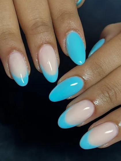 A bright and fun take on the French manicure with a vibrant blue tip.