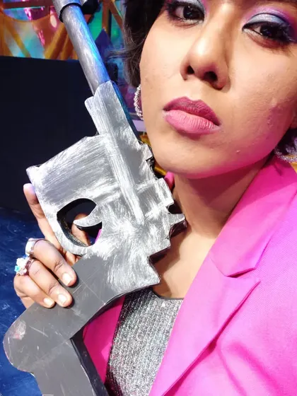 A memorable day on set, posing with a prop gun. I enjoy getting into character, and this look was for a high-energy, action-comedy performance.